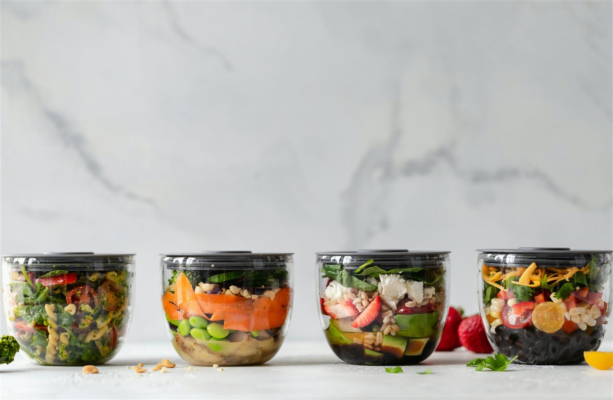 Neatly arranged meal prep containers with fresh vegetables