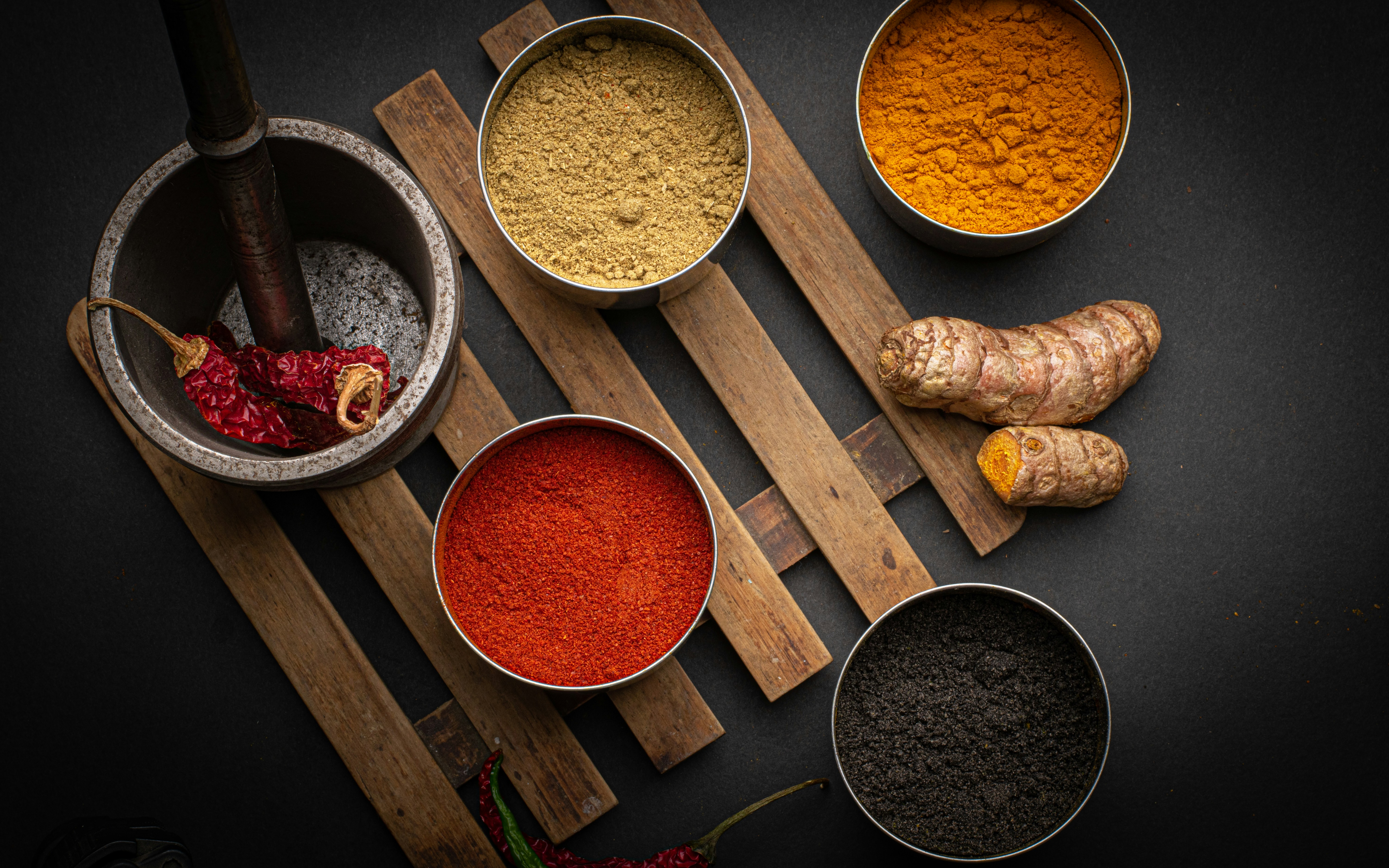 An array of dried herbs and spices in small jars
